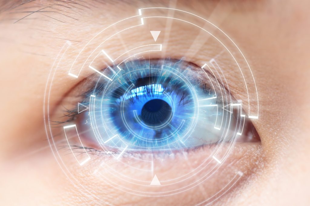 Close-up of woman's blue eye. High Technologies in the futuristic. : contact lens